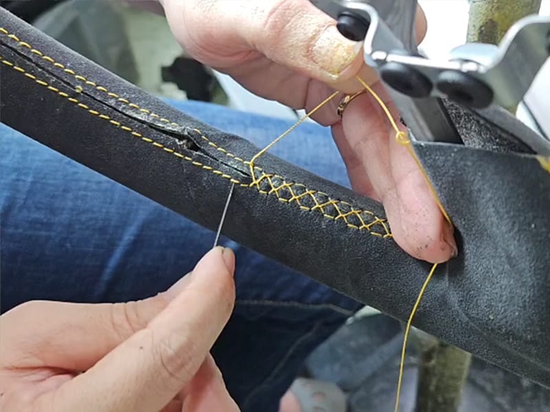 Hand stitching a custom leather steering wheel in Singapore