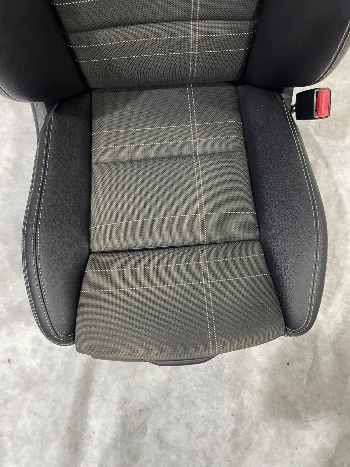 Close-up of replacement leather panel on repaired seat bolster
