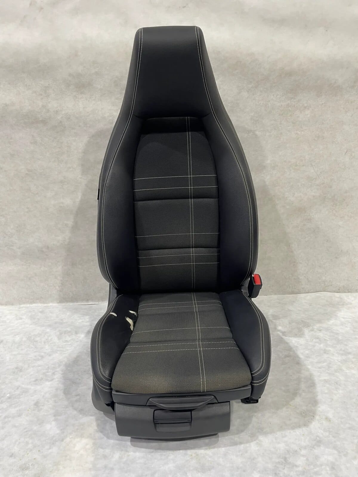 Mercedes-Benz seat with damaged outer leather bolster before panel replacement
